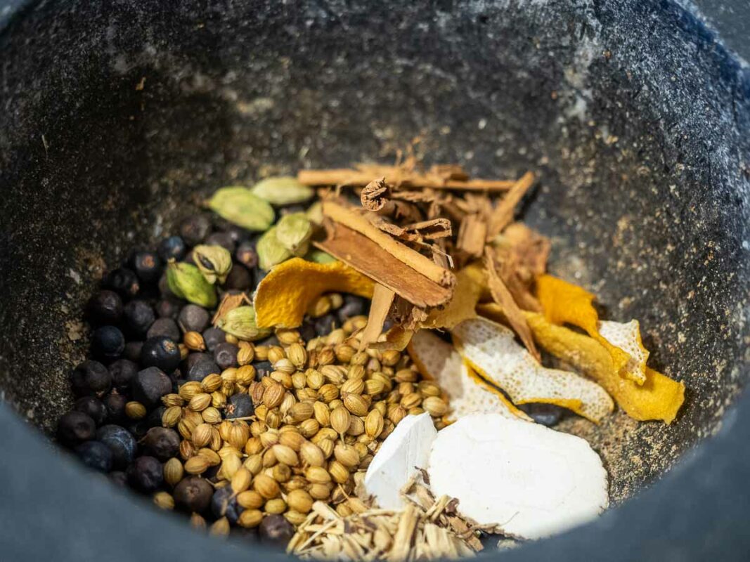 Image of DIY Distilling crushing gin botanicals for making old tom gin recipe